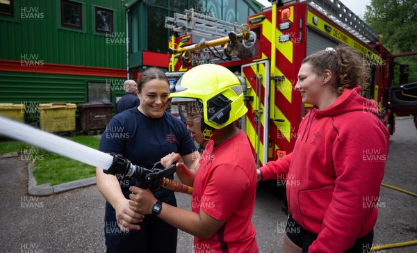 040526 - Wales Women Rugby with South Wales Fire Service - Wales International Squad member and South Wales Fire Service fire fighter Jenni Scoble brings her colleagues from Blue Watch Roath to meet and take part in team building with her Wales team members Jenni Scoble explains the hose operation to Jenna De Vera