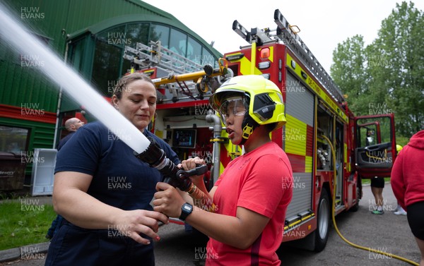 040526 - Wales Women Rugby with South Wales Fire Service - Wales International Squad member and South Wales Fire Service fire fighter Jenni Scoble brings her colleagues from Blue Watch Roath to meet and take part in team building with her Wales team members Jenni Scoble explains the hose operation to Jenna De Vera
