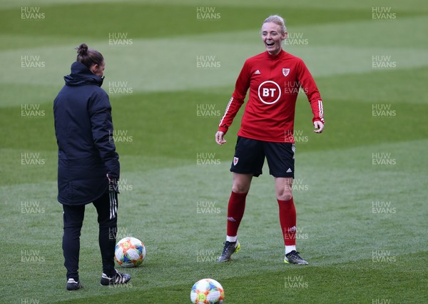 120421 Wales Women Football Training Session - Sophie Ingle of Wales shares a joke with assistant coach Loren Dykes during a training session at Cardiff City Stadium ahead of their friendly international match against Denmark