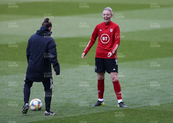 120421 Wales Women Football Training Session - Sophie Ingle of Wales shares a joke with assistant coach Loren Dykes during a training session at Cardiff City Stadium ahead of their friendly international match against Denmark