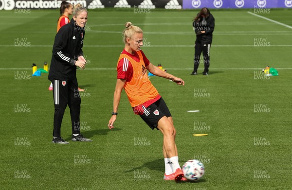 140921 - Wales Women Football Training Session - Sophie Ingle of Wales plays the ball watched by Wales manager Gemma Grainger during a training session ahead of their opening 2023 FIFA Women’s World Cup Qualifying Round matches against Kazakhstan and Estonia