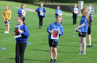 160921 - Wales Women Football Training Session - Pupils from Dolau Primary School, Llanharan, wait to make a surprise welcome for the members of the Wales Womens Football team, and pass on letters they have written to them, ahead of the team's opening 2023 FIFA Women’s World Cup Qualifying Round matches against Kazakhstan and Estonia