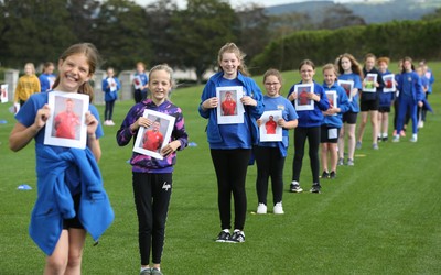 160921 - Wales Women Football Training Session - Pupils from Dolau Primary School, Llanharan, wait to make a surprise welcome for the members of the Wales Womens Football team, and pass on letters they have written to them, ahead of the team's opening 2023 FIFA Women’s World Cup Qualifying Round matches against Kazakhstan and Estonia