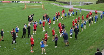 160921 - Wales Women Football Training Session - Pupils from Dolau Primary School, Llanharan, talk to members of the Wales Women's Football team after the pupils made a surprise visit to meet the team, and pass on letters they have written to them, ahead of the team's opening 2023 FIFA Women’s World Cup Qualifying Round matches against Kazakhstan and Estonia