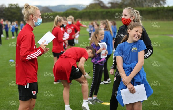 160921 - Wales Women Football Training Session - Wales Women captain Sophie Ingle chats with Eva Scott, aged 10, from Dolau Primary School, Llanharan, after the pupils made a surprise visit to meet the team, and pass on letters they have written to them in support, ahead of the team's opening 2023 FIFA Women’s World Cup Qualifying Round matches against Kazakhstan and Estonia