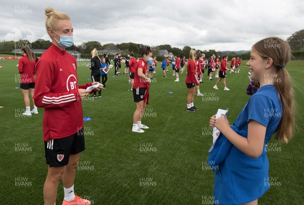 160921 - Wales Women Football Training Session - Wales Women captain Sophie Ingle chats with Eva Scott, aged 10, from Dolau Primary School, Llanharan, after the pupils made a surprise visit to meet the team, and pass on letters they have written to them in support, ahead of the team's opening 2023 FIFA Women’s World Cup Qualifying Round matches against Kazakhstan and Estonia