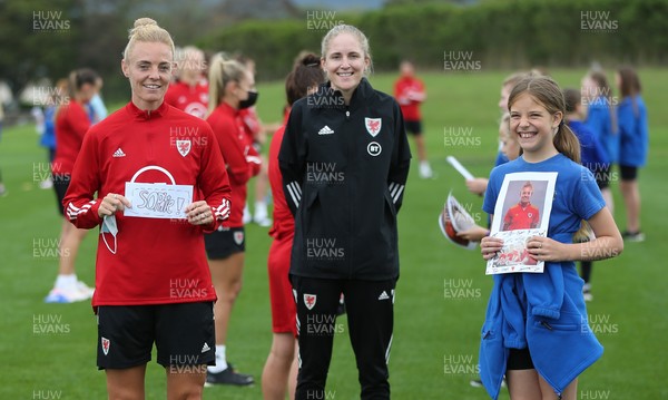 160921 - Wales Women Football Training Session - Wales Women captain Sophie Ingle and Wales manager Gemma Grainger with Eva Scott, aged 10, from Dolau Primary School, Llanharan, after the pupils made a surprise visit to meet the team, and pass on letters they have written to them in support, ahead of the team's opening 2023 FIFA Women’s World Cup Qualifying Round matches against Kazakhstan and Estonia