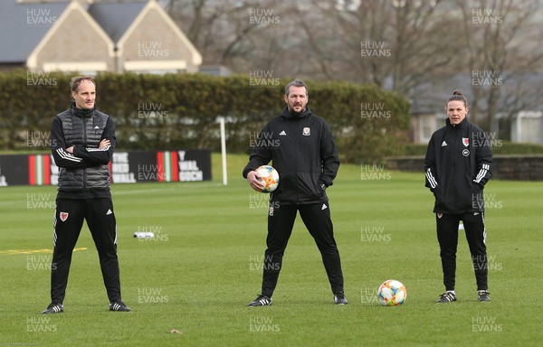 170221 - Wales Women Football Training Session - The Wales Women Football Squad interim coaching team of, left to right, interim coach David Adams, and interim assistant coaches Matty Jones and Loren Dykes, watch the squad warm up at a training session, the first since the departure of Jayne Ludlow as Wales national team manager