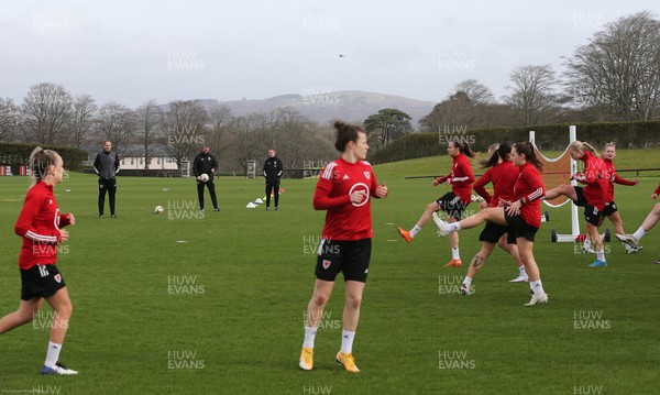 170221 - Wales Women Football Training Session - The Wales Women Football Squad interim coaching team of, left to right, interim coach David Adams, and interim assistant coaches Matty Jones and Loren Dykes, watch the squad warm up at a training session, the first since the departure of Jayne Ludlow as Wales national team manager