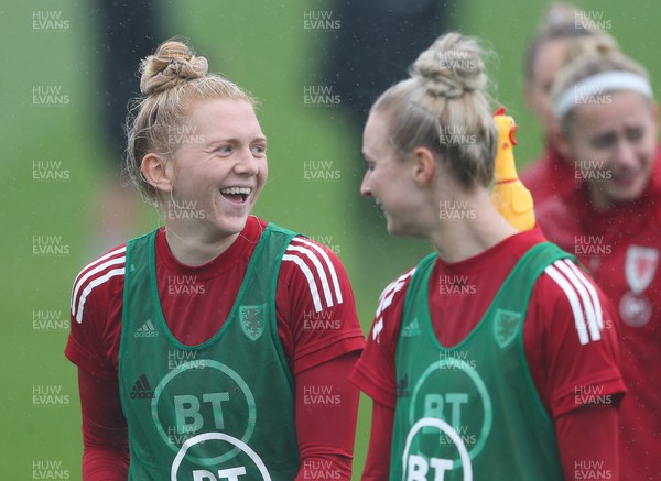 191021 - Wales Women Football Training - Rhiannon Roberts and Ceri Holland enjoy a joke with a rubber chicken used during a warm up game during a Wales Women training session ahead of the World Cup Qualifying matches against Slovenia and Estonia