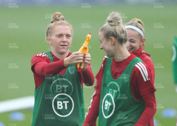 191021 - Wales Women Football Training - Ceri Holland and Rhiannon Roberts enjoy a joke with a rubber chicken used in a warm up game during a Wales Women training session ahead of the World Cup Qualifying matches against Slovenia and Estonia