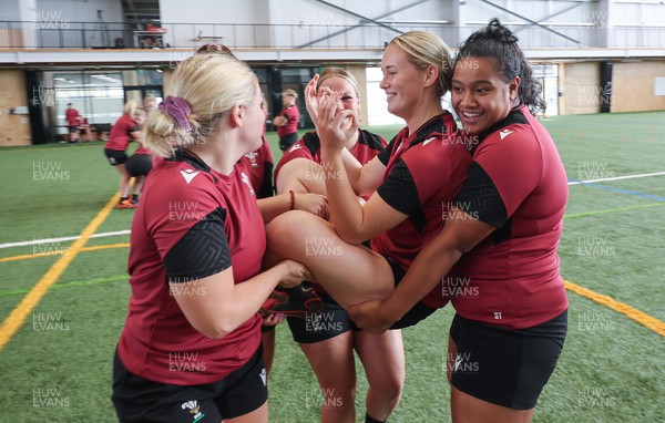 131023 - Wales Women Conditioning Session - Meg Webb is carried by Alex Callender and Sisilia Tuipulotu in a team building exercise during a skills and conditioning session on Wales’ first full day in Wellington, New Zealand ahead of the start of WXV1