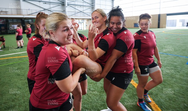 131023 - Wales Women Conditioning Session - Meg Webb is carried by Alex Callender and Sisilia Tuipulotu in a team building exercise during a skills and conditioning session on Wales’ first full day in Wellington, New Zealand ahead of the start of WXV1