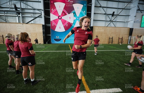 131023 - Wales Women Conditioning Session - Jazz Joyce celebrates as the Wales team take kicks and passes against a giant interactive video wall during a skills and conditioning session on Wales’ first full day in Wellington, New Zealand ahead of the start of WXV1