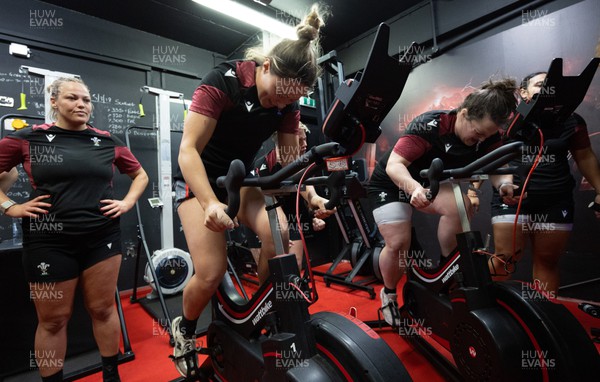 120324 - Wales Women Bike session -  Alisha Butchers and Abbey Constable are watched by Kelsey Jones during a bike session ahead of the start of the Women’s 6 Nations