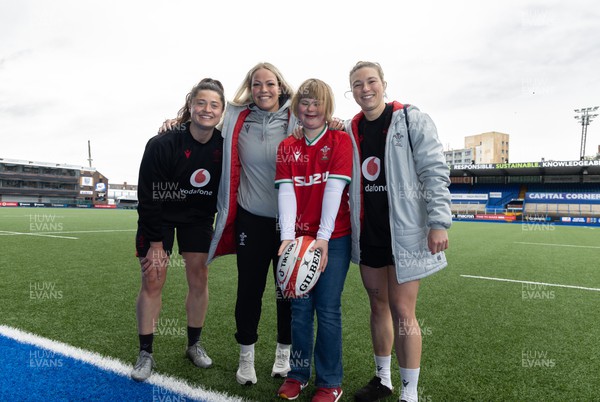 140423 - Wales Women Rugby Kickers Practice - Efa Amphlett-Jones, aged 11 from Newport, with Wales’ Robyn Wilkins, Kelsey Jones  and Keira Bevan at the end of kickers practice at Cardiff Arms Park ahead of the TicTok Women’s 6 Nations match against England tomorrow