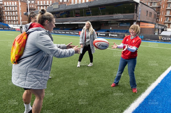 140423 - Wales Women Rugby Kickers Practice - Efa Amphlett-Jones, aged 11 from Newport, enjoys an impromptu training session with Wales’ Keira Bevan, Robyn Wilkins and Kelsey Jones at the end of kickers practice at Cardiff Arms Park ahead of the TicTok Women’s 6 Nations match against England tomorrow