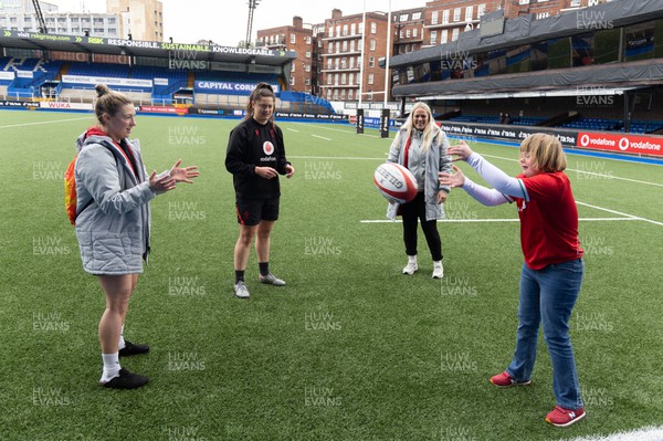 140423 - Wales Women Rugby Kickers Practice - Efa Amphlett-Jones, aged 11 from Newport, enjoys an impromptu training session with Wales’ Keira Bevan, Robyn Wilkins and Kelsey Jones at the end of kickers practice at Cardiff Arms Park ahead of the TicTok Women’s 6 Nations match against England tomorrow