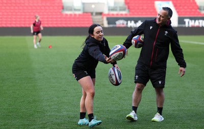 290324 - Wales Women Rugby Kickers Session - Sian Jones with Shaun Connor, Wales Women attack coach, during a kickers session at Ashton Gate ahead of the Guinness Women’s 6 Nations match against England