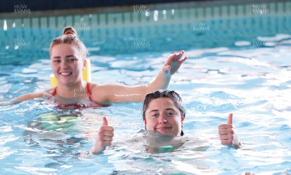 250423 - Wales Women Rugby Pool Recovery Session - Robyn Wilkins and Niamh Terry during a pool recovery session after training ahead of the TicTok Women’s 6 Nations match against Italy
