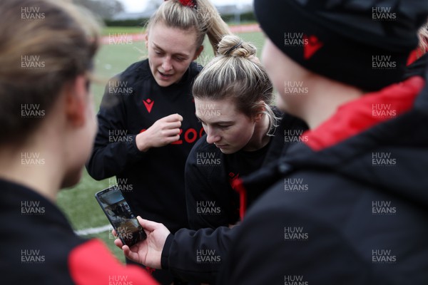 080222 - Behind the Scenes in the Wales Women Rugby Camp as they prepare for this years 6 Nations Championship - Hannah Jones and Keira Bevan watch a tiktok on Bethan Lewis� phone