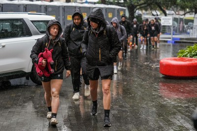 310725 - Wales Women Rugby Captain’s Run - Players and management  arrives in the rain for Wales’ Captain’s Run ahead of the second test against Australia
