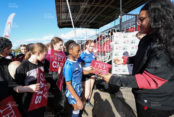 190424 - Wales Women Rugby Media session - Wales’ Sisilia Tuipulotu signs autographs and poses for photographs with players involved in the Urdd WRU 7s during a media session held at the event ahead of Wales’ Guinness 6 Nations match against France