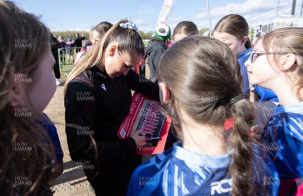 190424 - Wales Women Rugby Media session - Wales’ Kayleigh Powell signs autographs and poses for photographs with players involved in the Urdd WRU 7s during a media session held at the event ahead of Wales’ Guinness 6 Nations match against France