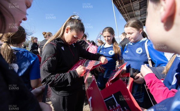 190424 - Wales Women Rugby Media session - Wales’ Kayleigh Powell signs autographs and poses for photographs with players involved in the Urdd WRU 7s during a media session held at the event ahead of Wales’ Guinness 6 Nations match against France