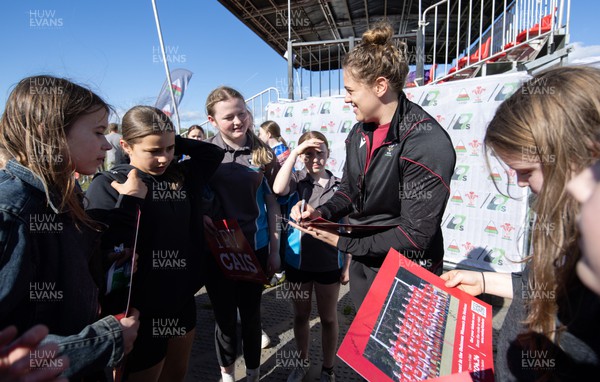 190424 - Wales Women Rugby Media session - Wales’ Natalia John signs autographs and poses for photographs with players involved in the Urdd WRU 7s during a media session held at the event ahead of Wales’ Guinness 6 Nations match against France