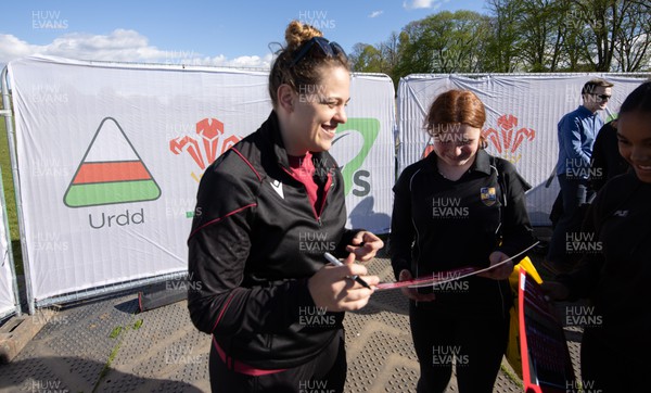 190424 - Wales Women Rugby Media session - Wales’ Natalia John signs autographs and poses for photographs with players involved in the Urdd WRU 7s during a media session held at the event ahead of Wales’ Guinness 6 Nations match against France