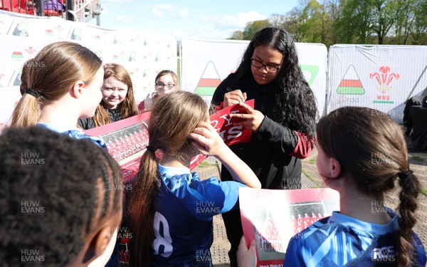 190424 - Wales Women Rugby Media session - Wales’ Sisilia Tuipulotu signs autographs and poses for photographs with players involved in the Urdd WRU 7s during a media session held at the event ahead of Wales’ Guinness 6 Nations match against France