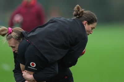 030426 - Wales Women Rugby Training session - Jasmine Joyce is tackled by Hannah Dallavalle during training ahead of the start of the Women’s 6 Nations