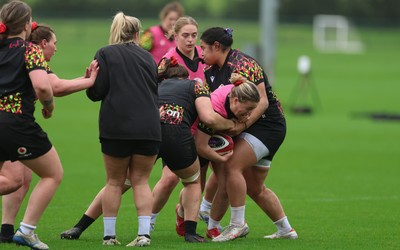 030426 - Wales Women Rugby Training session - Molly Reardon is held by Sisilia Tuipulotu during training ahead of the start of the Women’s 6 Nations