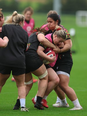 030426 - Wales Women Rugby Training session - Molly Reardon is held by Sisilia Tuipulotu during training ahead of the start of the Women’s 6 Nations