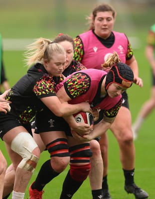 030426 - Wales Women Rugby Training session - Bethan Lewis is held by Seren Lockwood during training ahead of the start of the Women’s 6 Nations