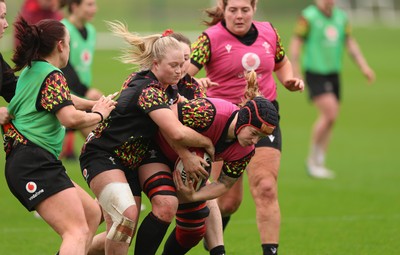 030426 - Wales Women Rugby Training session - Bethan Lewis is held by Seren Lockwood during training ahead of the start of the Women’s 6 Nations