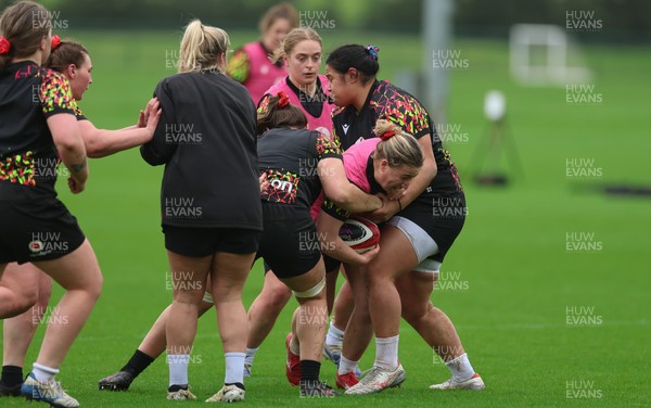 030426 - Wales Women Rugby Training session - Molly Reardon is held by Sisilia Tuipulotu during training ahead of the start of the Women’s 6 Nations