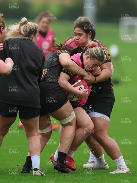 030426 - Wales Women Rugby Training session - Molly Reardon is held by Sisilia Tuipulotu during training ahead of the start of the Women’s 6 Nations