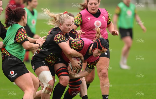 030426 - Wales Women Rugby Training session - Bethan Lewis is held by Seren Lockwood during training ahead of the start of the Women’s 6 Nations