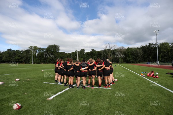 050722 - Wales Women Rugby Squad back in training as the road to the World Cup begins - Wales team huddle during training
