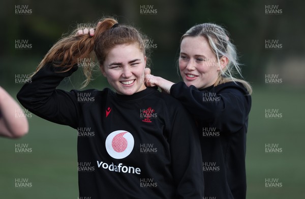 060423 -  Wales Women Rugby Squad Training session - Megan Webb helps Niamh Terry with her gps unit during a training session ahead of their TicTok Women’s 6 Nations match against England