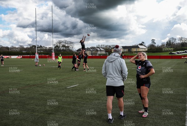 060423 -  Wales Women Rugby Squad - Kelsey Jones works with Wales assistant coach Mike Hill during a training session ahead of their TicTok Women’s 6 Nations match against England