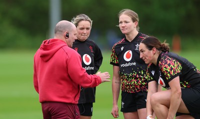 060526 - Wales Women Rugby Training Session - Sean Lynn, Wales Women head coach with Freya Bell, Carys Cox and Courtney Keight during training ahead of the 6 Nations match against Ireland