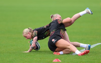 060526 - Wales Women Rugby Training Session - Nikita Prothero is tackled by Seren Singleton during training ahead of the 6 Nations match against Ireland