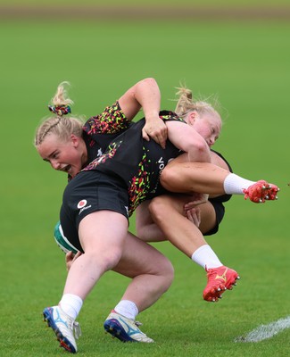 060526 - Wales Women Rugby Training Session - Seren Singleton is tackled by Seren Lockwood during training ahead of the 6 Nations match against Ireland