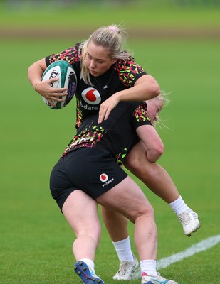 060526 - Wales Women Rugby Training Session - Kelsie Webster is tackled by Seren Lockwood during training ahead of the 6 Nations match against Ireland