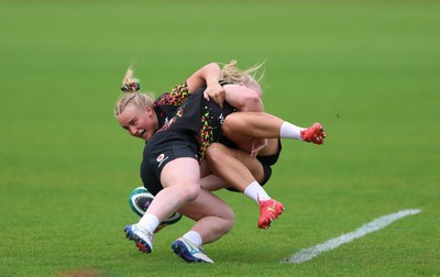 060526 - Wales Women Rugby Training Session - Seren Lockwood tackles Seren Singleton during training ahead of the 6 Nations match against Ireland