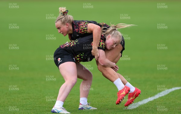 060526 - Wales Women Rugby Training Session - Seren Singleton is tackled by Seren Lockwood during training ahead of the 6 Nations match against Ireland