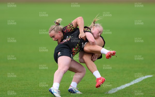 060526 - Wales Women Rugby Training Session - Seren Singleton is tackled by Seren Lockwood during training ahead of the 6 Nations match against Ireland